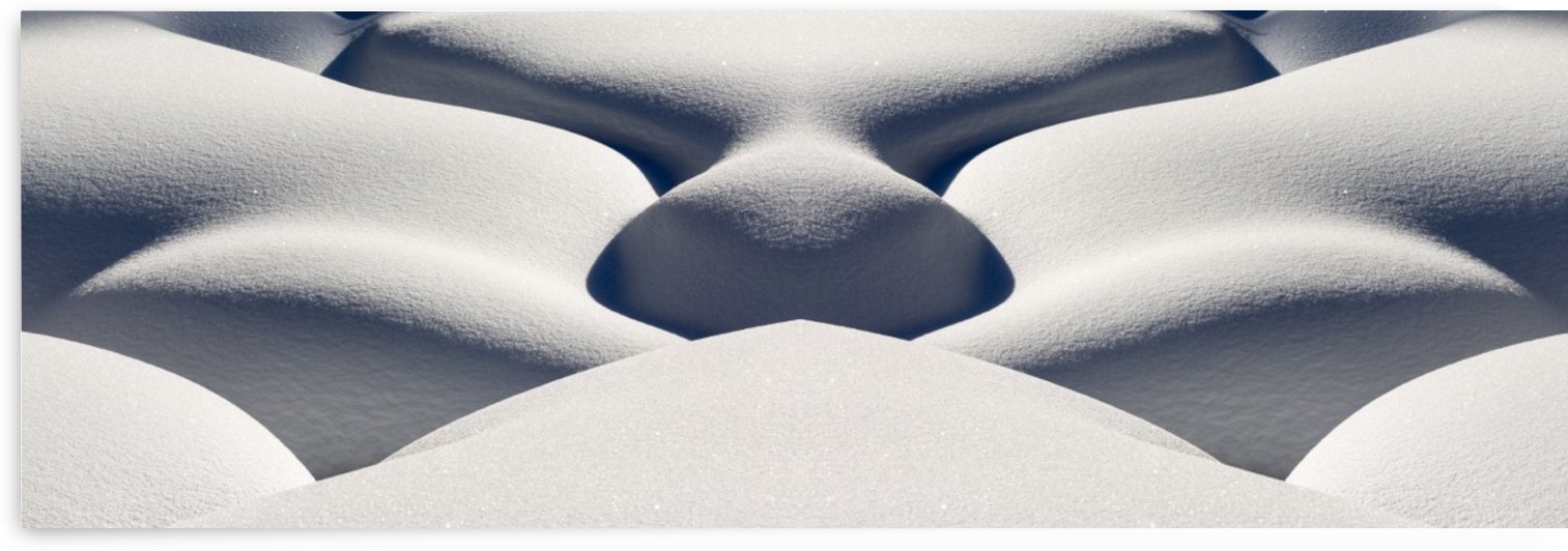 Artistic montage of snow contouring a creek bed with graphic designs of curving highlights and shadows; Lake Louise, Alberta, Canada by PacificStock