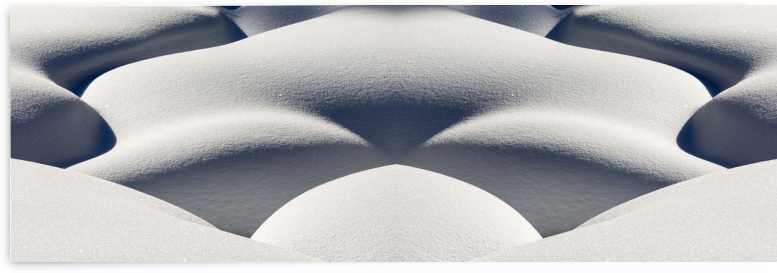 Artistic montage of snow contouring a creek bed with graphic designs of curving highlights and shadows; Lake Louise, Alberta, Canada by PacificStock