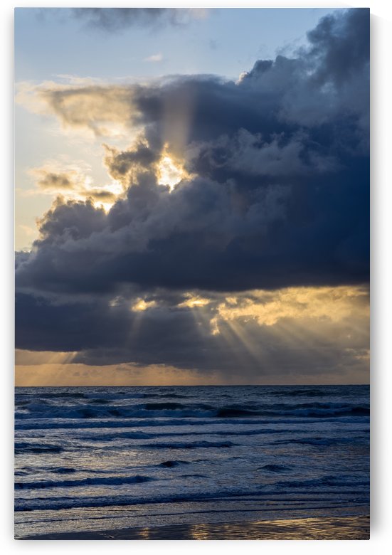 Sunbeams flow through holes in the clouds along the Oregon Coast; Cannon Beach, Oregon, United States of America by PacificStock