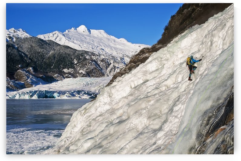 Female Ice Climber Climbs The Frozen Nugget Falls With Mendenhall Glacier In The Background, Juneau, Southeast Alaska, Winter by PacificStock