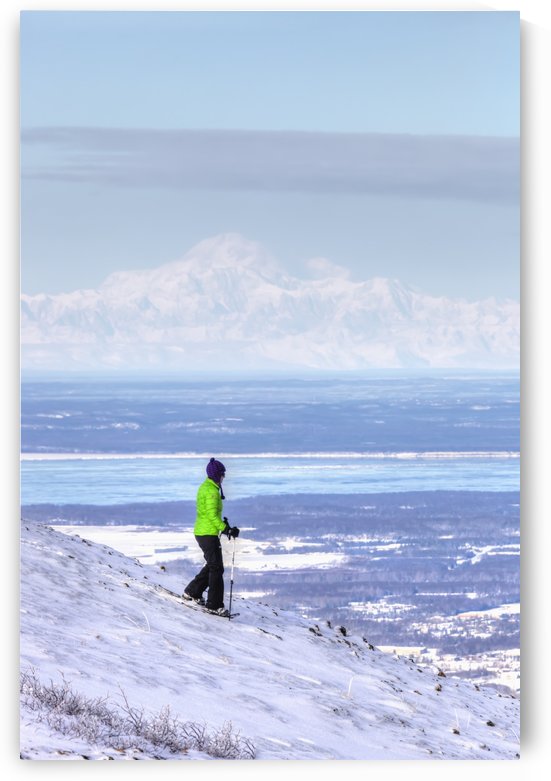 Woman snowshoeing on Blueberry Hill at the Glen Alps area of Chugach State Park with Mt. McKinley (Denali) in the background, Anchorage, Southcentral Alaska, Winter, HDR by PacificStock