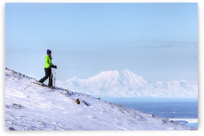 Woman snowshoeing on Blueberry Hill at the Glen Alps area of Chugach State Park with Mt. Foraker in the background, Anchorage, Southcentral Alaska, Winter, HDR by PacificStock