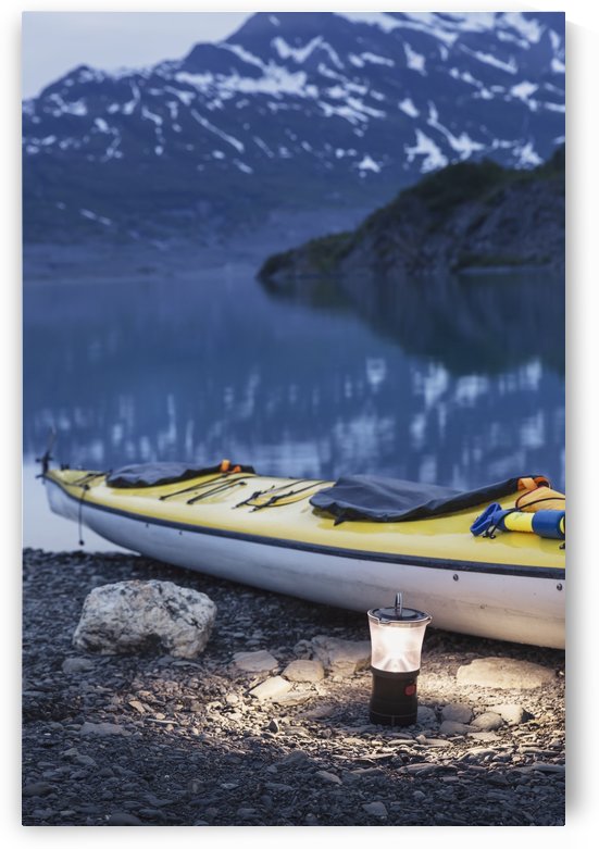 Kayak and lantern on the beach with mountains in the back ground at dusk, Shoup Bay State Marine Park, Prince William Sound, Valdez, Southcentral Alaska by PacificStock