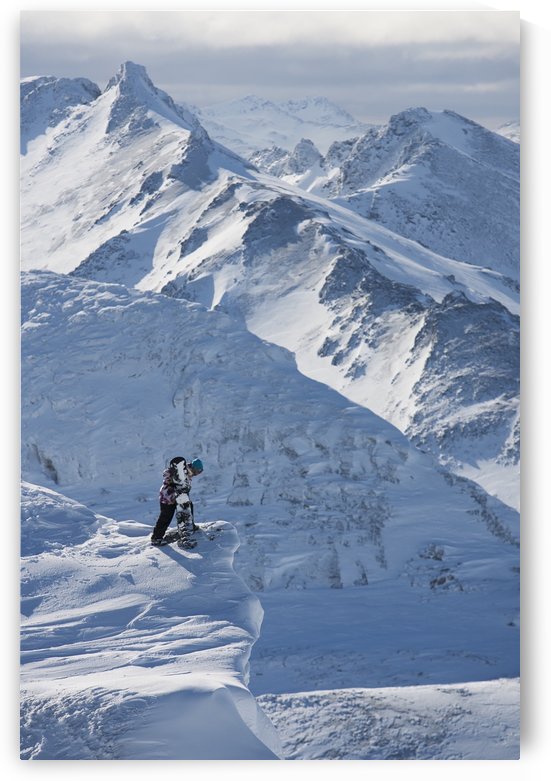 Professional snowboarder looking over the ledge at extreme terrain, Ushuaia, Patagonia, Argentina, South America by PacificStock
