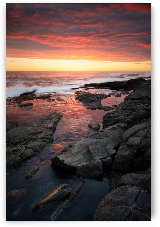Sunset over rocky coastline by Johan Swanepoel