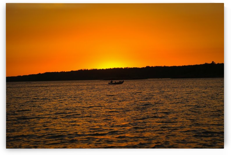 SUNSET AND BOAT BY THE WATER by Michael