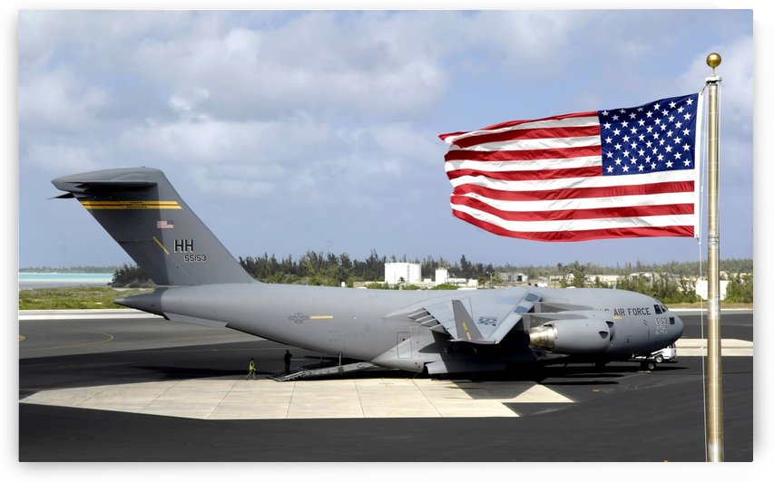 C-17 Globemaster III sits on the flightline at Wake Island. by StocktrekImages