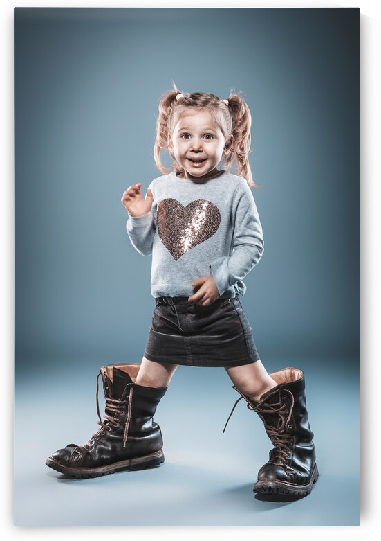 blonde girl plays with big boots. by Gualtiero Boffi