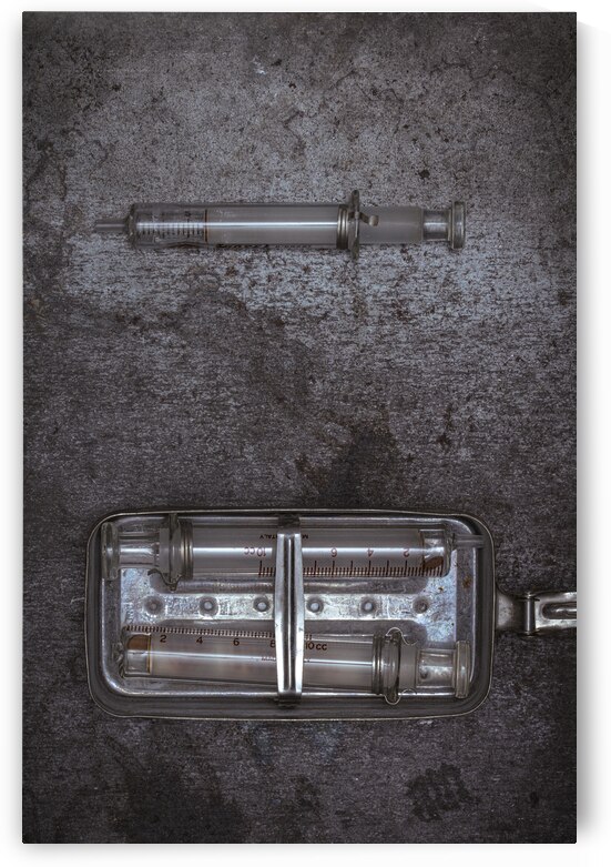 old glass syringes in metal box  by Gualtiero Boffi