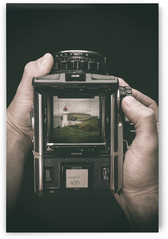 hands hold a medium format film camera dark background by Gualtiero Boffi