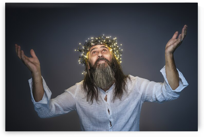 man with crown of led lights and raised arms  by Gualtiero Boffi