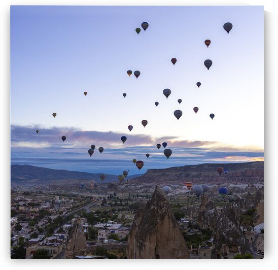 several hot air balloons fly at dawn in the sky of goreme by Gualtiero Boffi