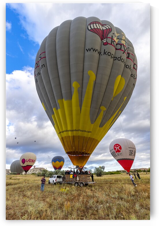  hot air balloons landing in goreme hills by Gualtiero Boffi
