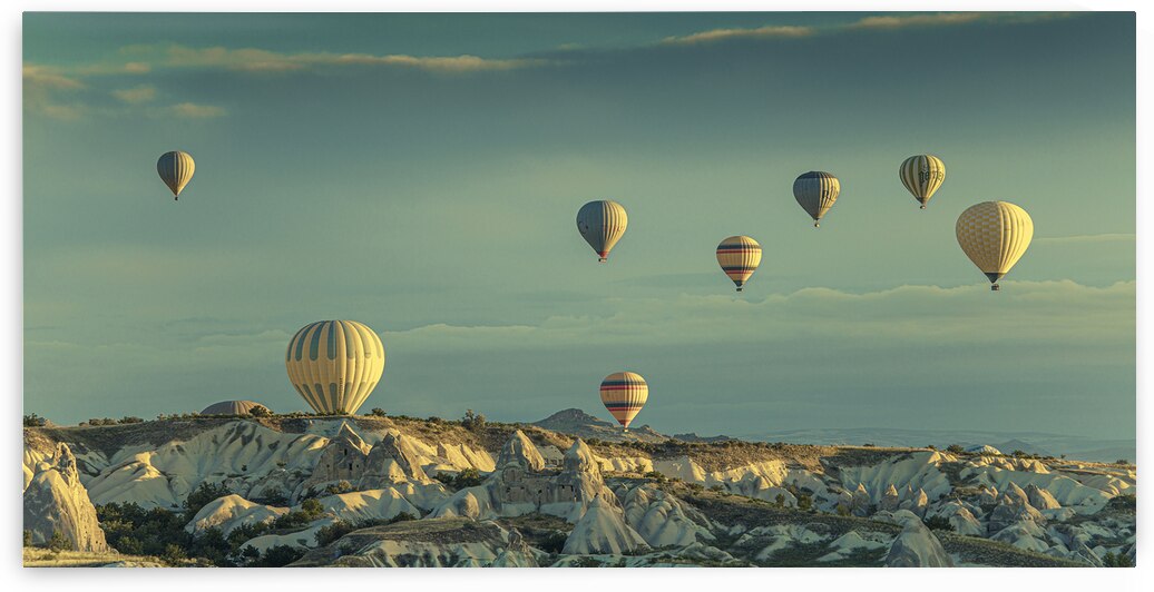 hot air balloons fly over goreme at dawn. by Gualtiero Boffi