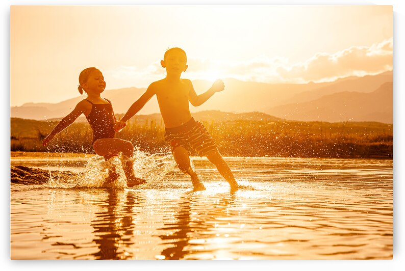 portrait of two children aged 3 and 6 playing in the sea and spr by Gualtiero Boffi