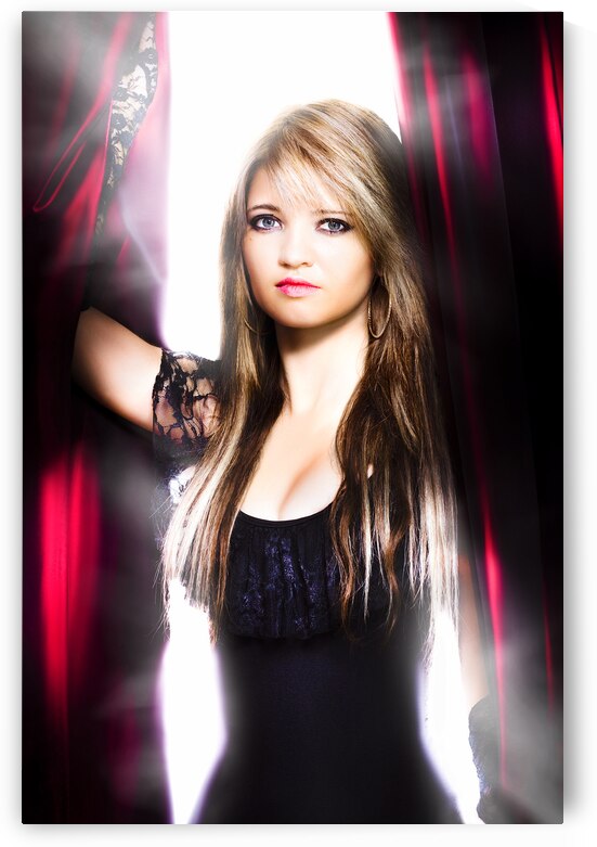 Female performer behind the stage curtain light by Jorgo