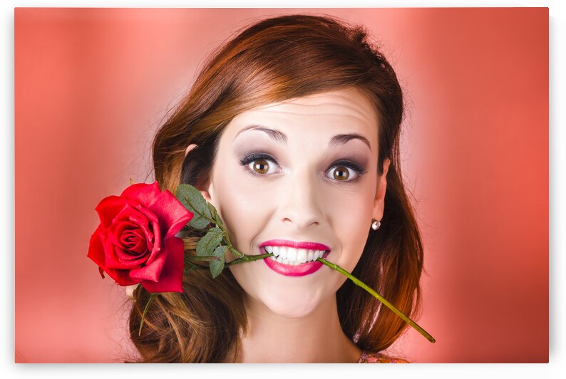 Woman gripping red rose between her teeth by Jorgo