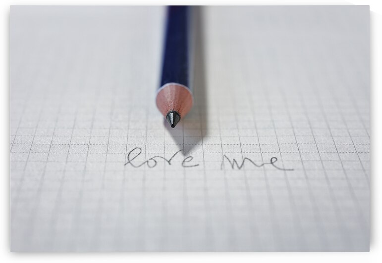 Words LOVE ME on paper and pencil by victimewalker