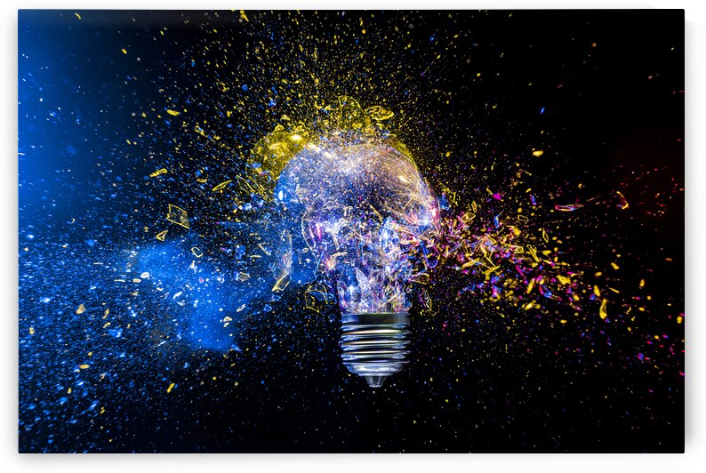 Light bulb exploding in colorful powder on black background by Gualtiero Boffi
