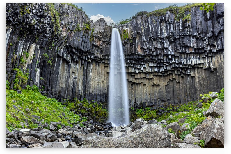 Powerful waterfall cascading over a dramatic cliff face in icela by Gualtiero Boffi