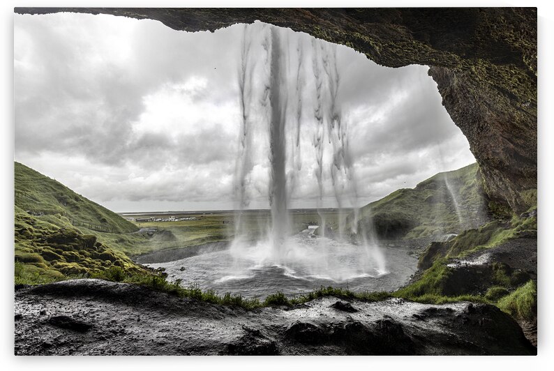 Seljalandsfoss waterfall crashing down on a cloudy day in icelan by Gualtiero Boffi
