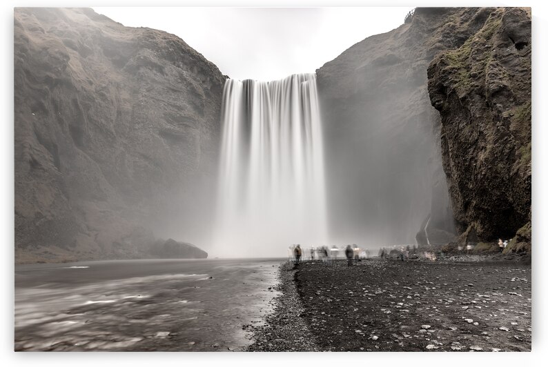 Skogafoss waterfall cascading from volcanic cliffs with tourists by Gualtiero Boffi