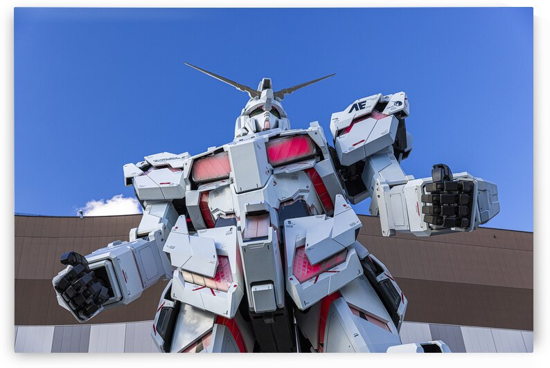 Giant gundam robot standing tall against blue sky in odaiba by Gualtiero Boffi