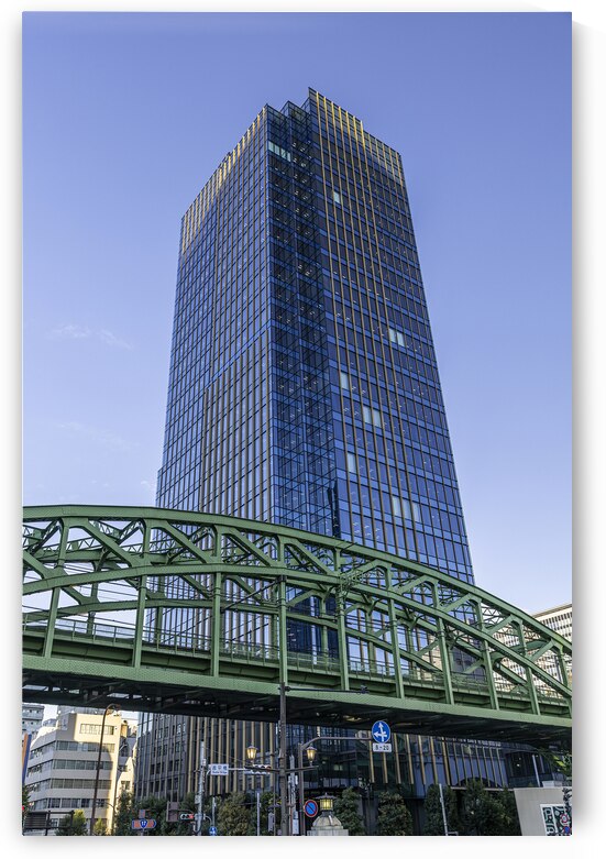 Modern glass office tower rising above green train bridge by Gualtiero Boffi