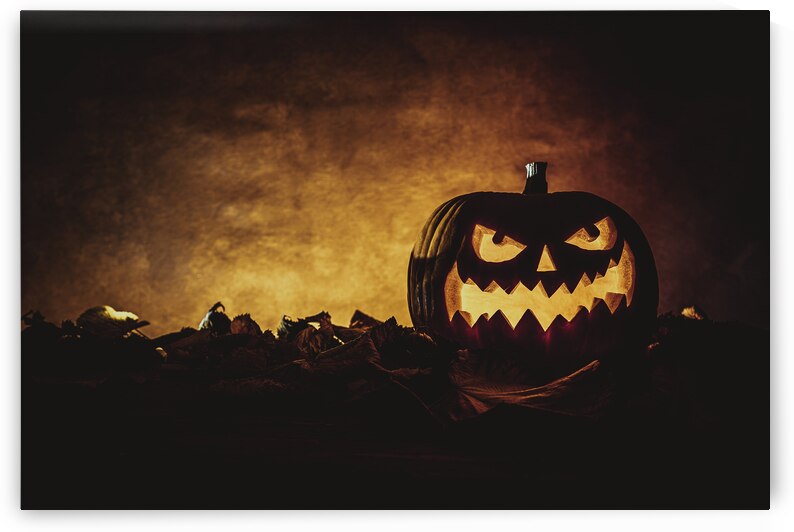 Halloween pumpkin glowing on autumn leaves background by Gualtiero Boffi