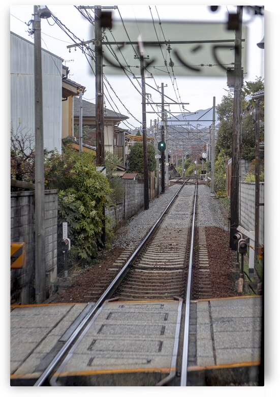 Train approaching empty rural japanese train station platform by Gualtiero Boffi
