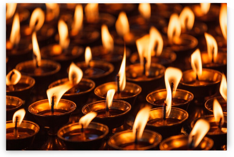 Burning candles in Buddhist temple by Dmitry Rukhlenko
