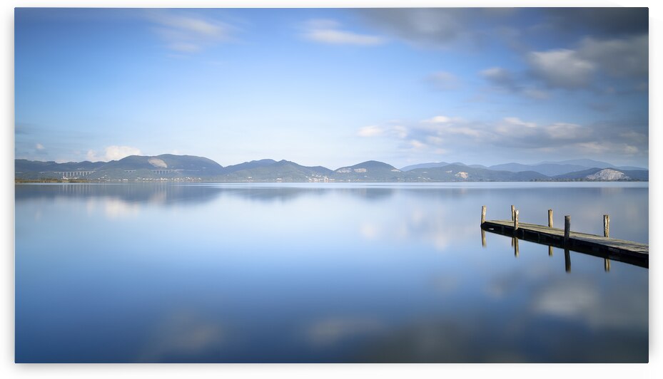 Wooden pier at sunset in Lake Massaciuccoli by Stefano Orazzini