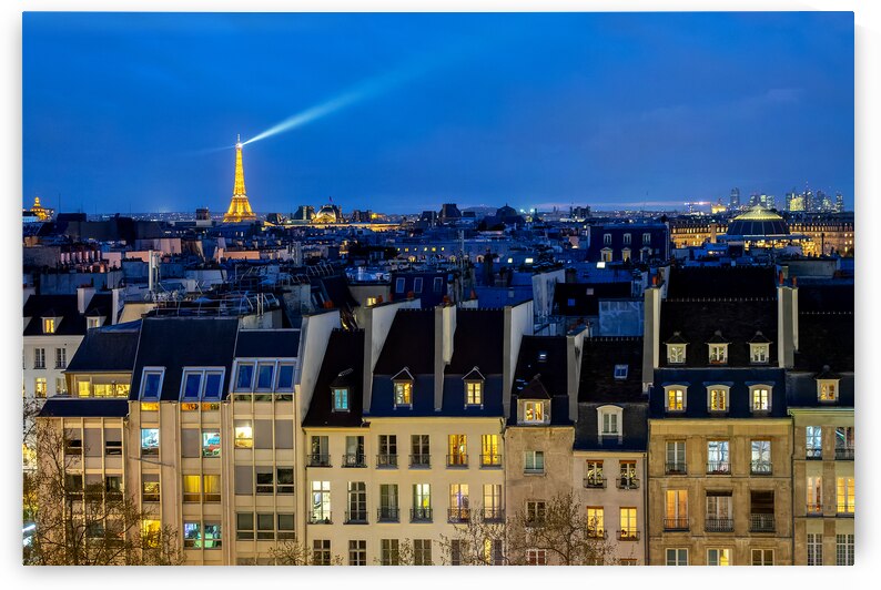 View of the roofs of Paris at night by DELPHIMAGES
