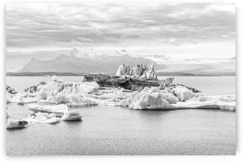 Icebergs floating on jokulsarlon glacier lagoon with mountains i by Gualtiero Boffi