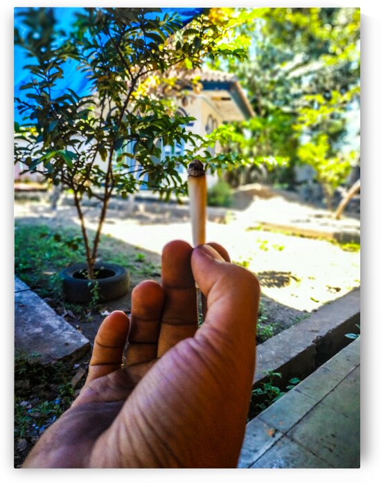 Hand Holding a Traditional Cigarette in a Serene by urbancamshot