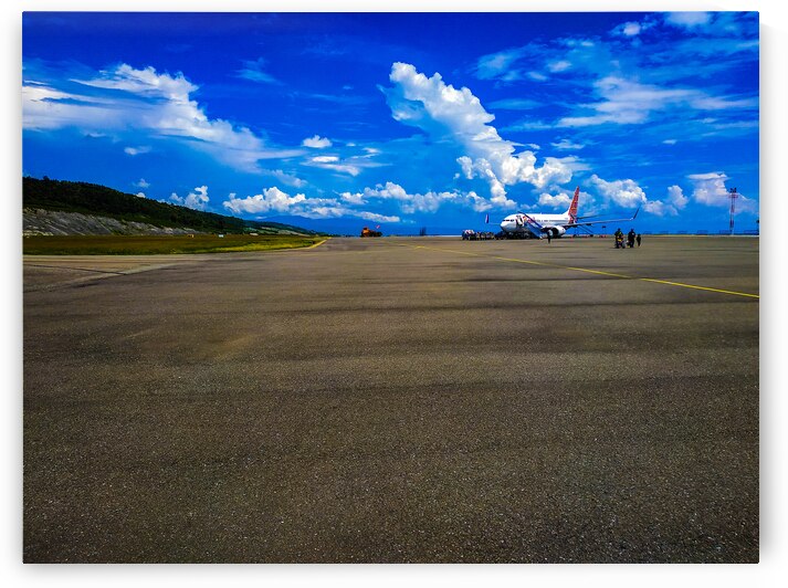 Airplane on Tarmac with Scenic Mountain Background by urbancamshot