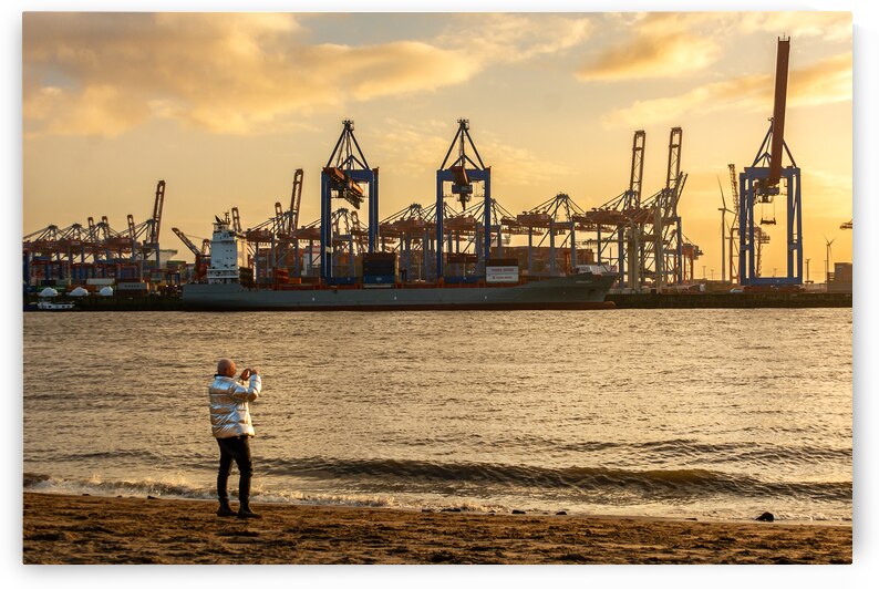 Man taking pictures at the Elbe River in Hamburg in front of harbor district at sunset by caladoart