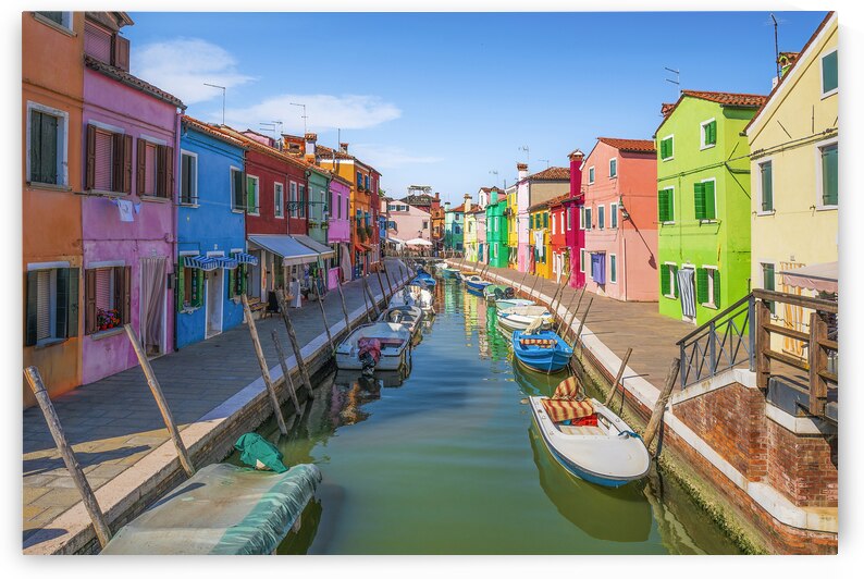 Burano island canal with colorful houses and boats by Stefano Orazzini