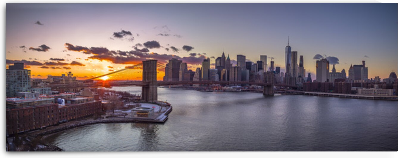 Evening view of Lower Manhattan skyline with Brooklyn bridge over East river New York by Assaf Frank