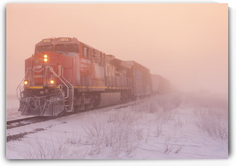a locomotive pulling general freight  in winter by Dave Reede Photohgraphy