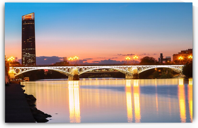 Triana or Isabel II bridge over the river Guadalquivir at sunset Sevilla Andalucia Spain by Kova  