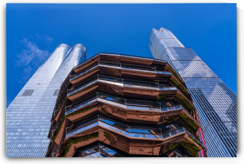 Reflective surface of the Vessel with a skyscraper behind with c by Steve Heap