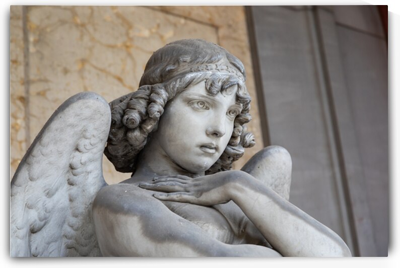 Cemetery statue of sad angel expressing solitude by Paolo Modena