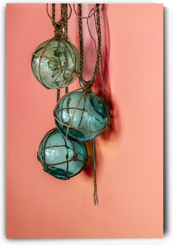 Glass fishing floats hanging on a wall by Lisa von Biela