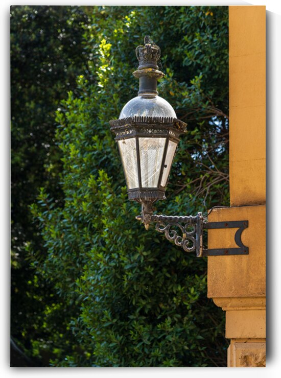 Historic english street lantern attached to warm stone building by Steve Heap