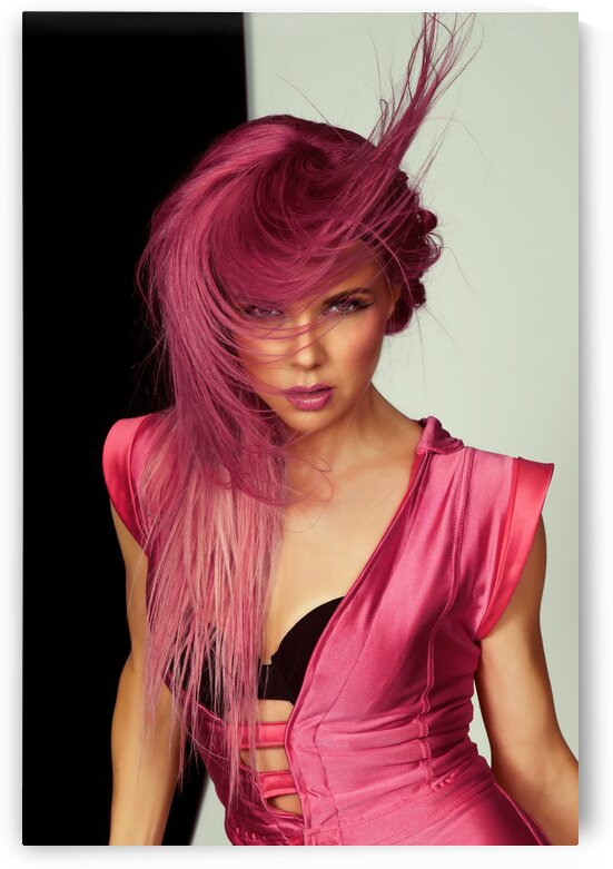 Portrait of a beautiful young woman in a pink one-piece jumpsuit looking at the camera in front of a black and white background her raspberry colored hair flying around by Artmood Visualz