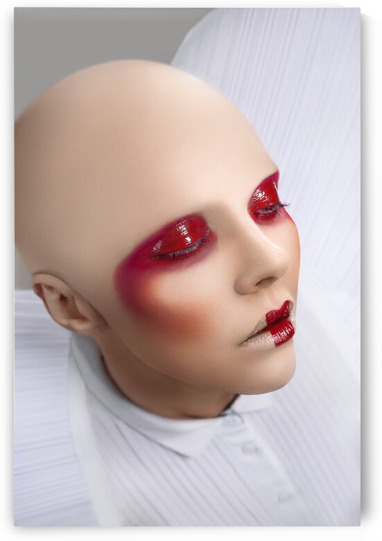 Close up of a bald woman wearing a white dress with large shoulder pads and glossy red makeup eyes closed in a white space by Artmood Visualz