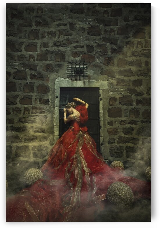Rear view of a beautiful young blonde woman wearing an elegant red and gold princess gown and golden jewels leaning against a dungeon door by Artmood Visualz