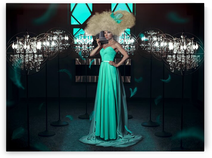 Beautiful and elegant woman wearing a turquoise gown with a big blonde wig her head in a round cage surrounded with lights and flying feathers in a dark room by Artmood Visualz