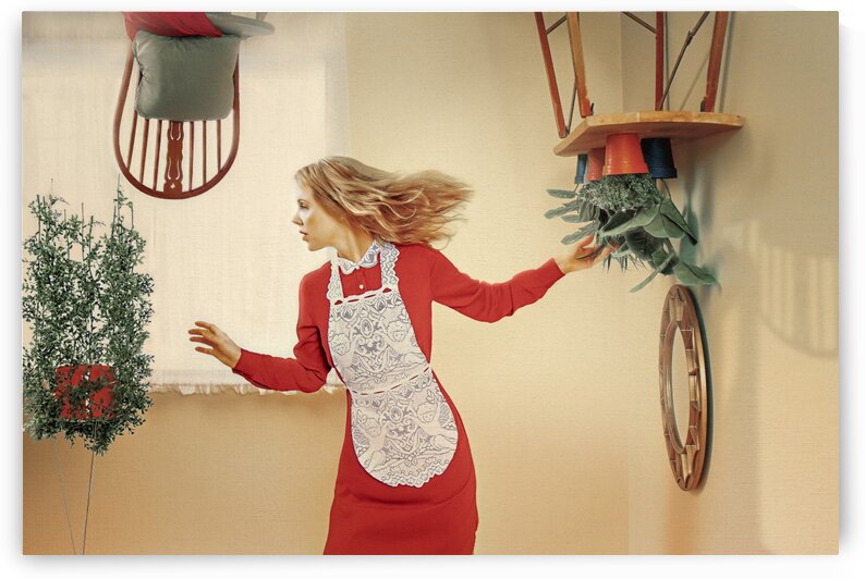 Busy young blonde woman in a red dress with a white lace apron taking care of her plants in a upside down bright room by Artmood Visualz